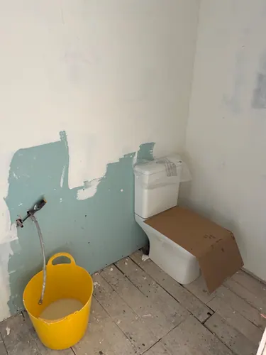 WC set in place against newly boarded and painted walls
