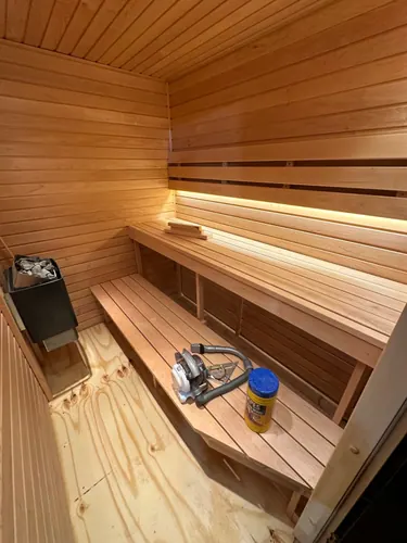 Close view of the bench build, stone-filled heater and under-bench lighting