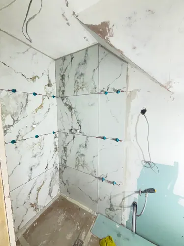 Tiling carried up the shower walls with the shower cable left out