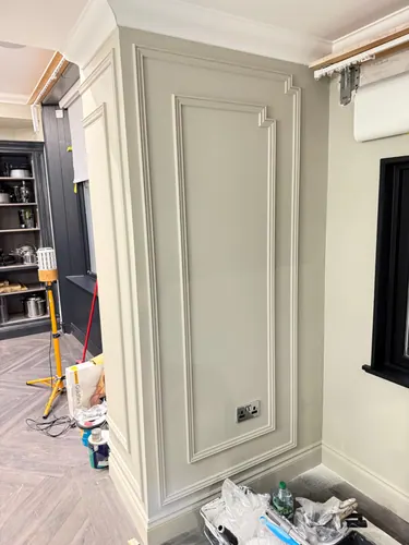 Painted panel with double socket set centrally within the moulded frame