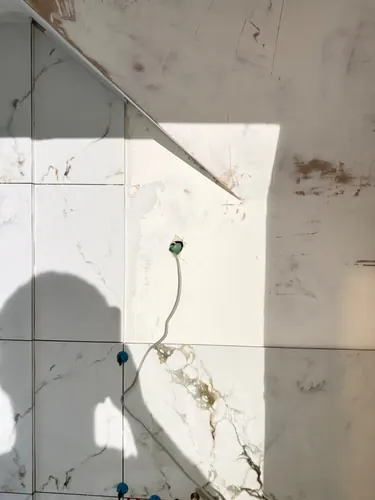 Cable left through a cut-out in the tiling for the ceiling light