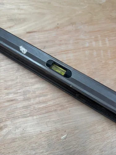 Close-up of a spirit level vial reading level on the ply floor