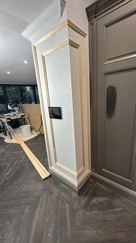 Close view of the column mouldings and recessed wall panel before painting