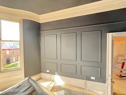 Panelling and walls painted dark grey with the cornice left in a light shade