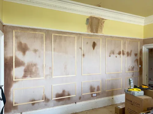 Panel frames fixed across the full wall of the second room