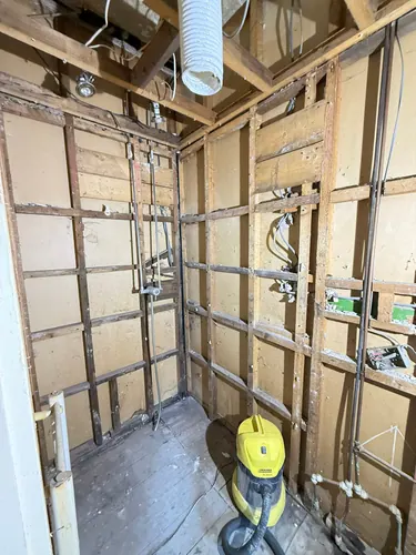 First fix wiring, extractor ducting and pipework run through the stud walls