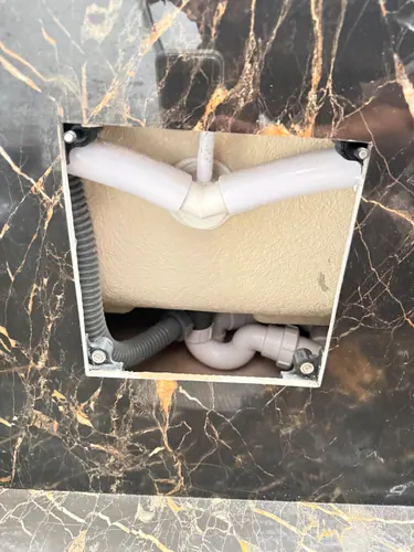 Open access panel showing the bath waste and trap connections