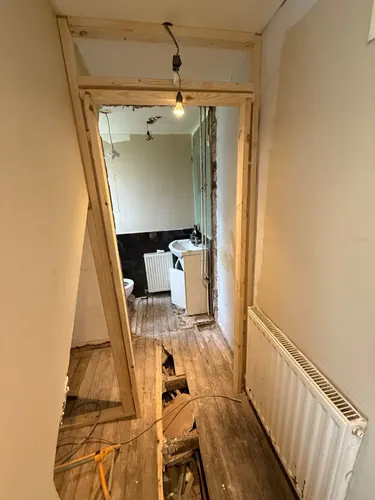 View through the new stud opening to the old basin and radiator