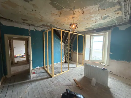Timber stud partition framed out in the corner of the bedroom