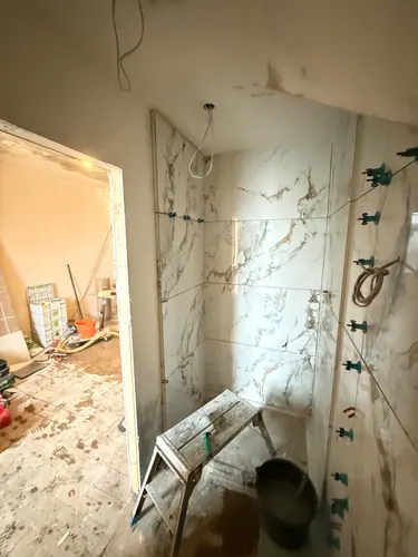 View from the bedroom door into the part-tiled en-suite